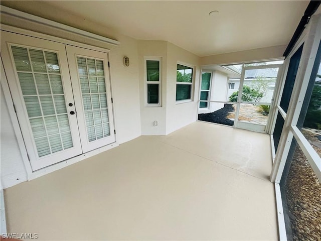 unfurnished sunroom with french doors