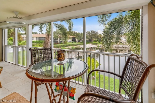 sunroom / solarium with a water view