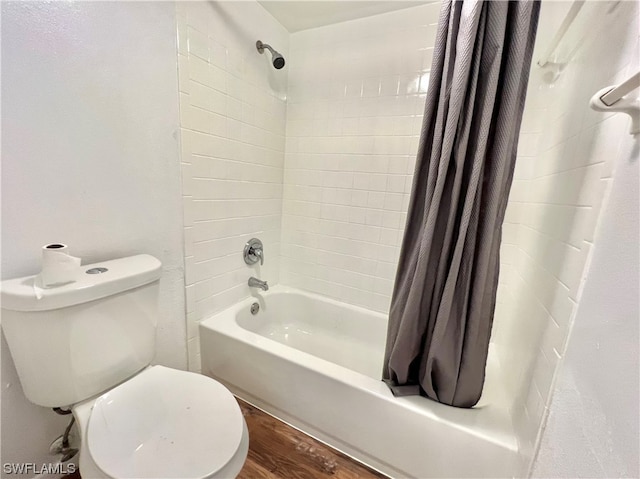 bathroom with hardwood / wood-style floors, shower / tub combo, and toilet