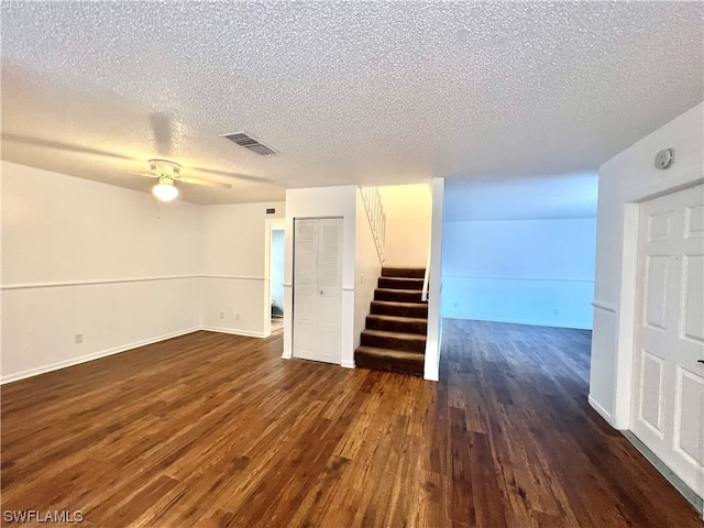 spare room featuring a textured ceiling, dark hardwood / wood-style floors, and ceiling fan