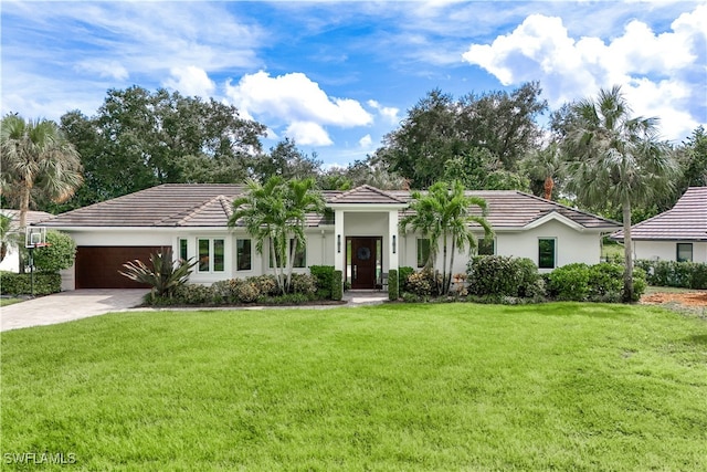 view of front of house with a garage and a front lawn