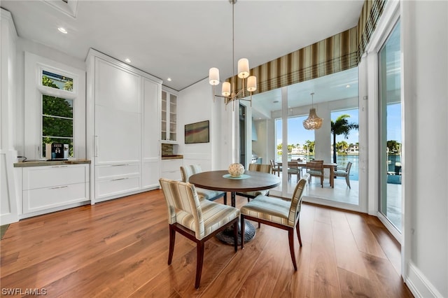 dining space featuring light hardwood / wood-style floors, a chandelier, and a wealth of natural light