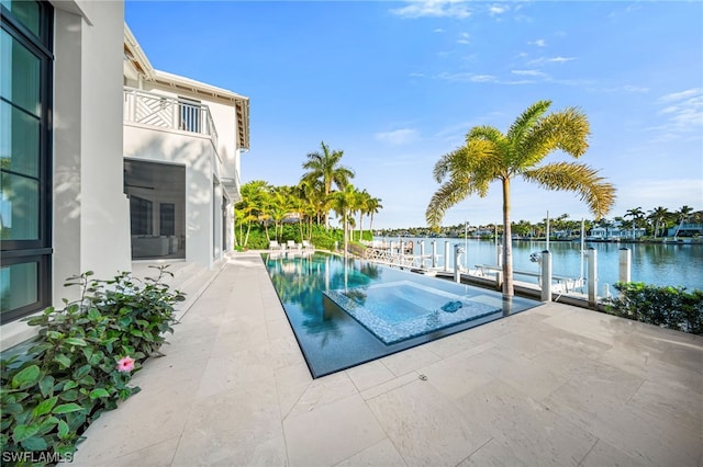 view of pool featuring a boat dock, a patio, and a water view