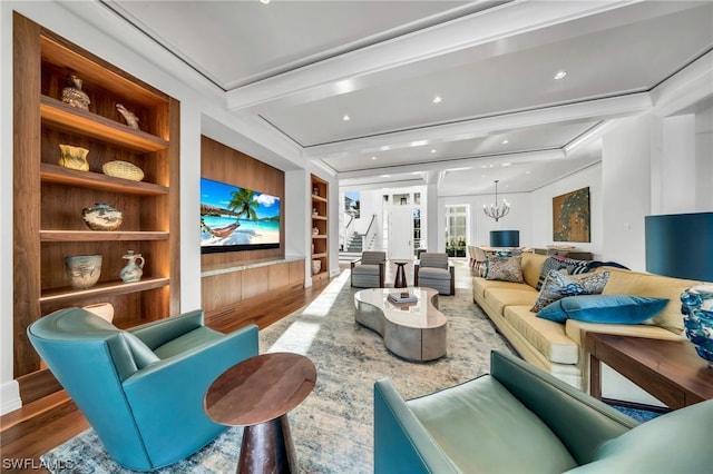 living room featuring built in features, a chandelier, hardwood / wood-style flooring, and beam ceiling