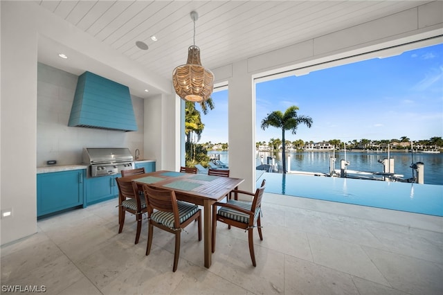 tiled dining area featuring a water view