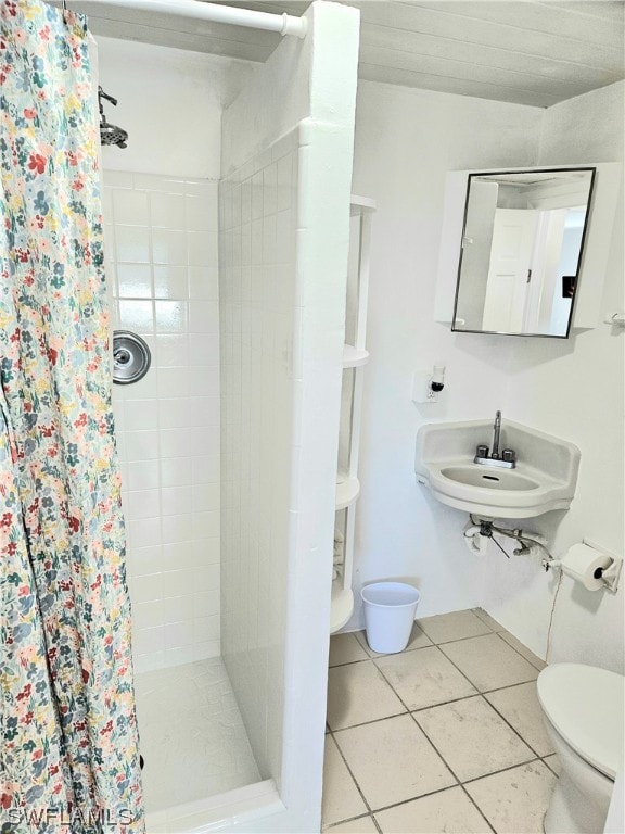 bathroom with sink, tile patterned flooring, a shower with curtain, and toilet