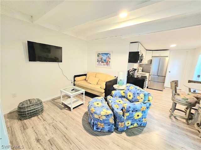 living room featuring beam ceiling and light hardwood / wood-style flooring