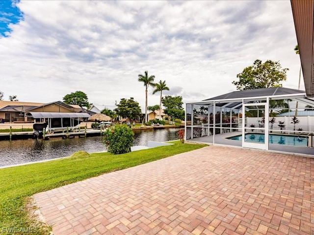 view of patio / terrace with a dock, a water view, and glass enclosure