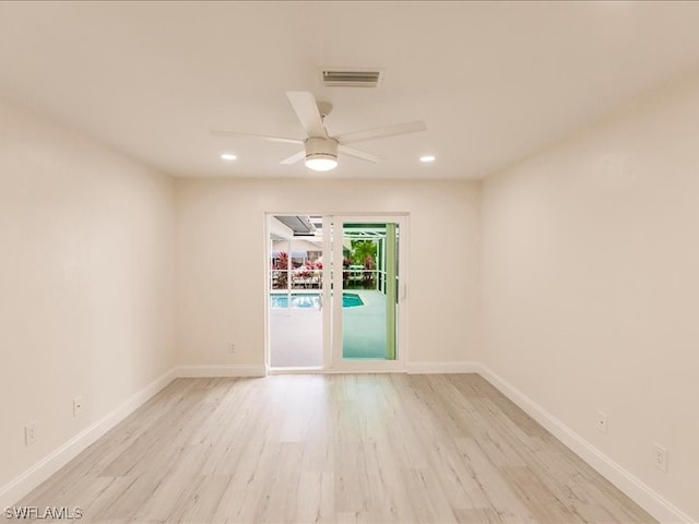 empty room with ceiling fan and light wood-type flooring