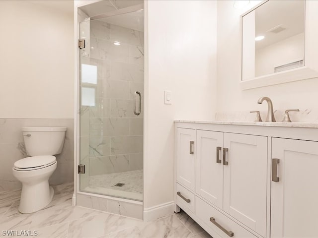 bathroom with an enclosed shower, vanity, tile flooring, and toilet