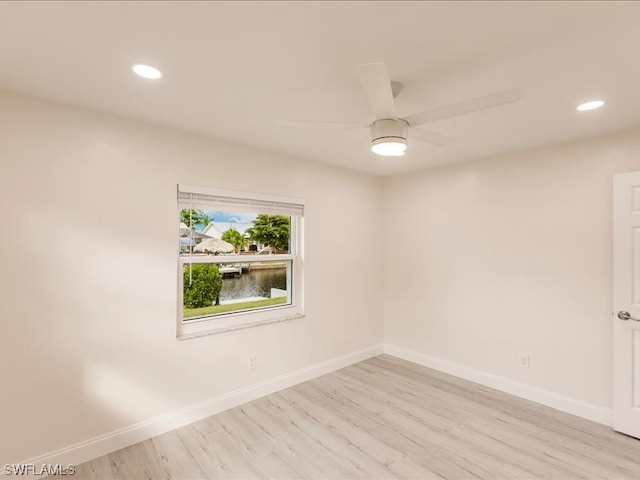 empty room featuring ceiling fan and light wood-type flooring