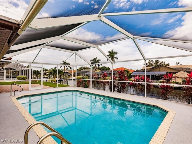 view of pool with a patio and glass enclosure