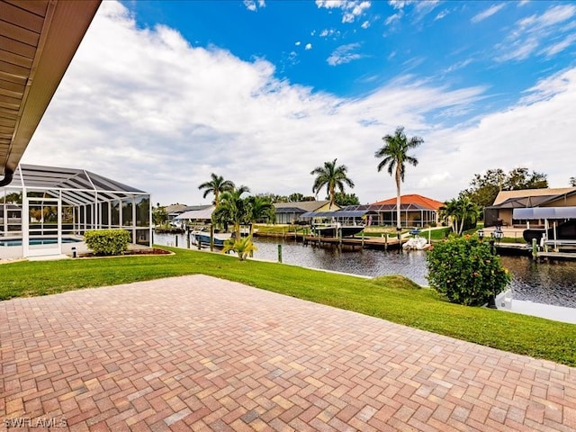 view of patio with a water view, a boat dock, and glass enclosure