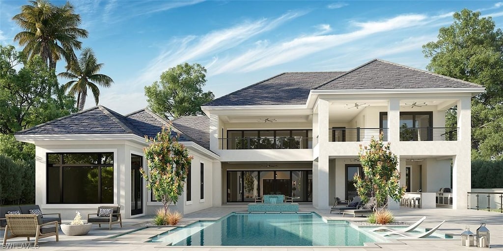 back of property featuring ceiling fan, a balcony, and a patio area