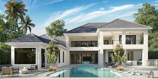 back of property featuring ceiling fan, a balcony, and a patio area