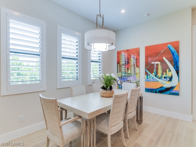 dining space with light hardwood / wood-style flooring