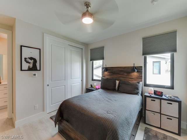 bedroom featuring light hardwood / wood-style floors, a closet, and ceiling fan