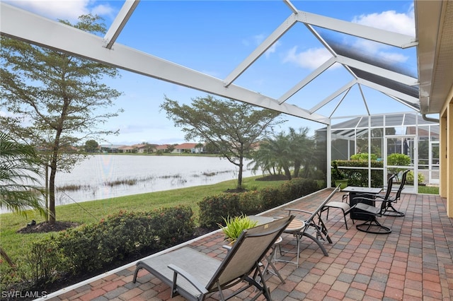 sunroom featuring a water view