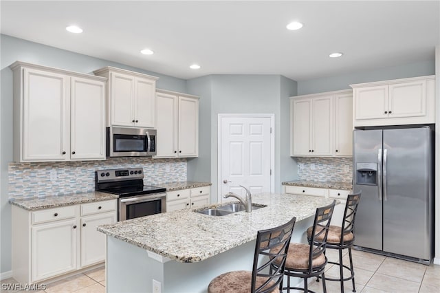 kitchen with backsplash, a breakfast bar area, and stainless steel appliances