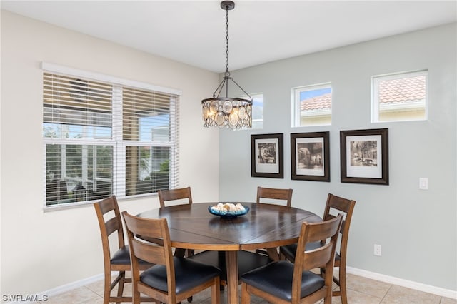 tiled dining space featuring plenty of natural light and a notable chandelier