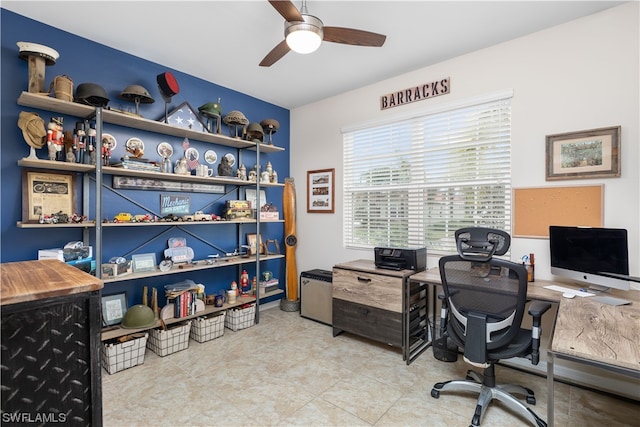 tiled home office featuring ceiling fan