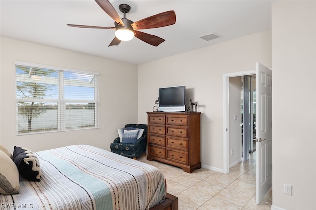 tiled bedroom featuring ceiling fan