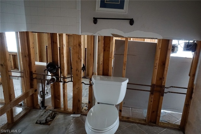 bathroom with toilet and tile patterned floors