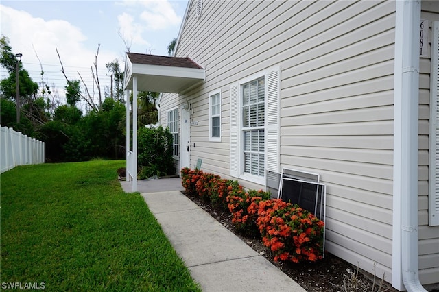 view of side of home featuring a lawn