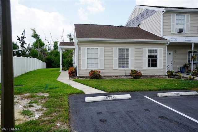 exterior space with cooling unit and a yard