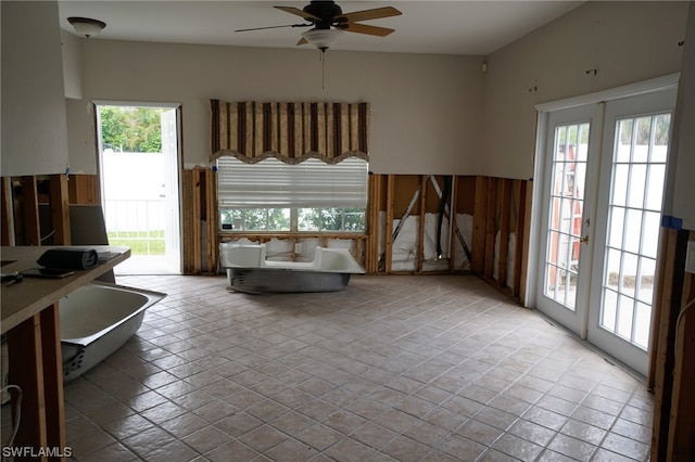 tiled living room featuring french doors and ceiling fan