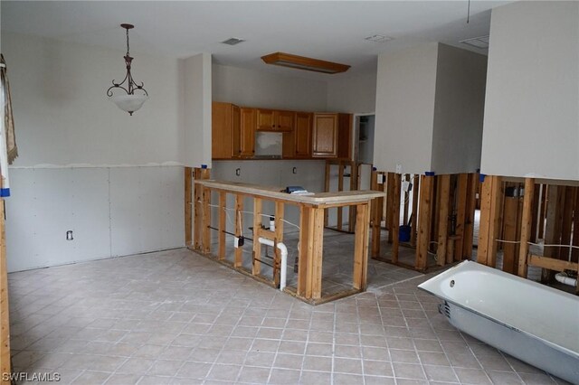 kitchen with pendant lighting and light tile patterned floors