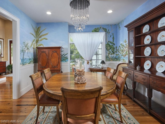 dining area featuring dark wood-type flooring and a chandelier