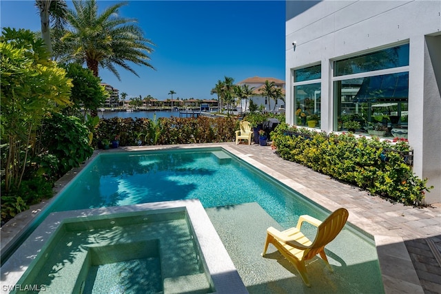 view of swimming pool with an in ground hot tub