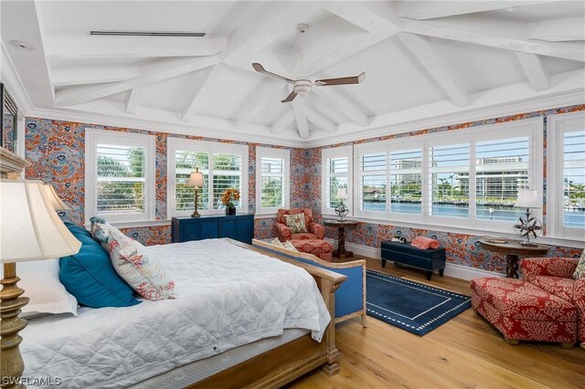 bedroom featuring vaulted ceiling with beams, light wood-type flooring, and ceiling fan