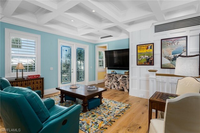 living room featuring coffered ceiling, french doors, ornamental molding, beam ceiling, and light hardwood / wood-style flooring