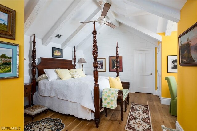 bedroom featuring ceiling fan, lofted ceiling with beams, and hardwood / wood-style flooring