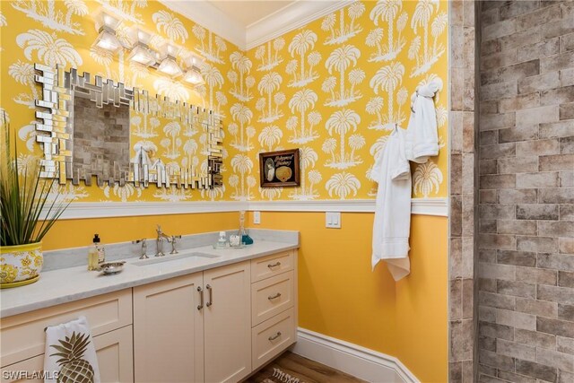 bathroom featuring ornamental molding and vanity