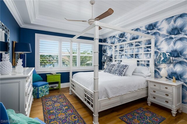 bedroom with ceiling fan, hardwood / wood-style flooring, and ornamental molding