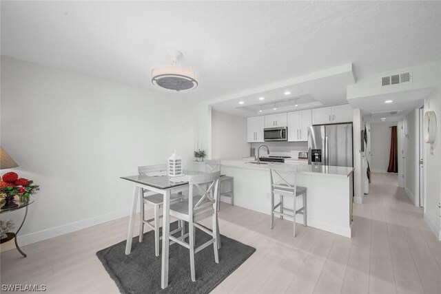 dining space featuring light hardwood / wood-style floors