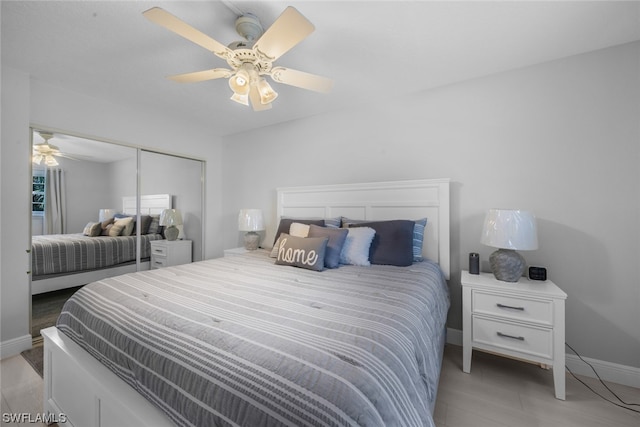 bedroom featuring light hardwood / wood-style floors, a closet, and ceiling fan