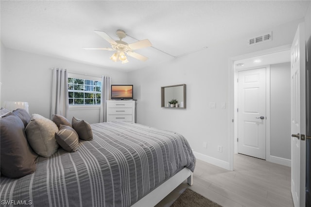 bedroom with light hardwood / wood-style flooring and ceiling fan