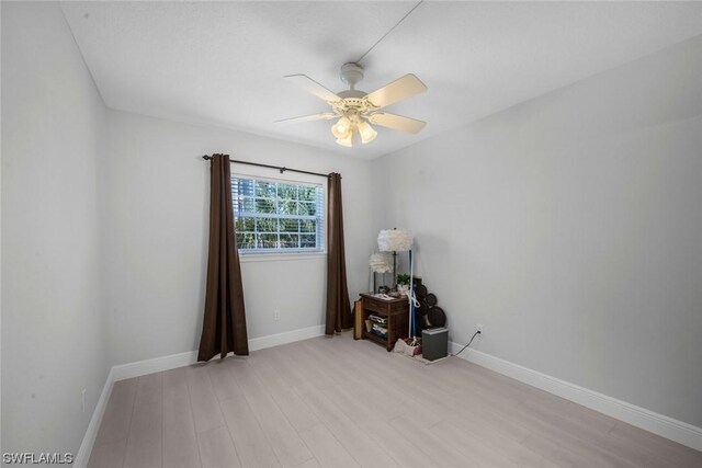 spare room featuring light wood-type flooring and ceiling fan