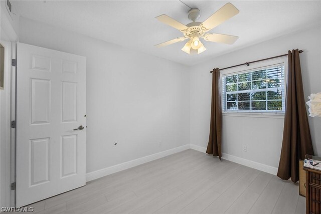 empty room with light hardwood / wood-style flooring and ceiling fan