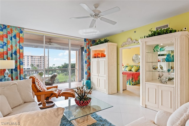 sitting room with ceiling fan and light tile patterned flooring