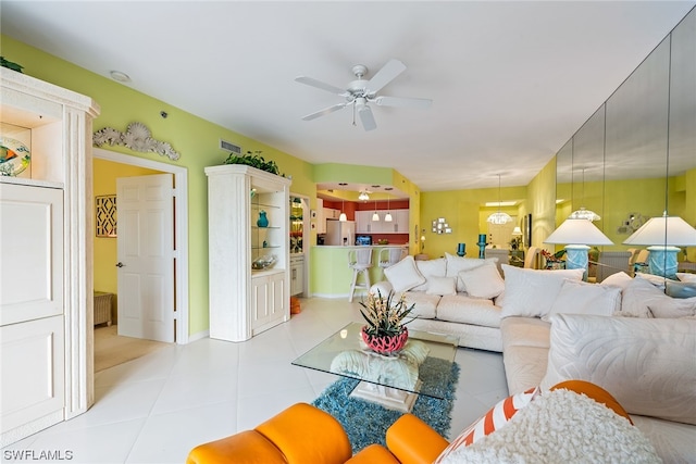 living room featuring light tile patterned floors and ceiling fan