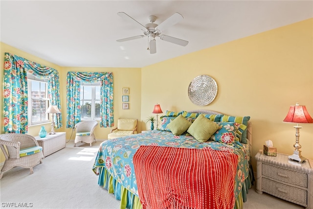 bedroom featuring ceiling fan and carpet