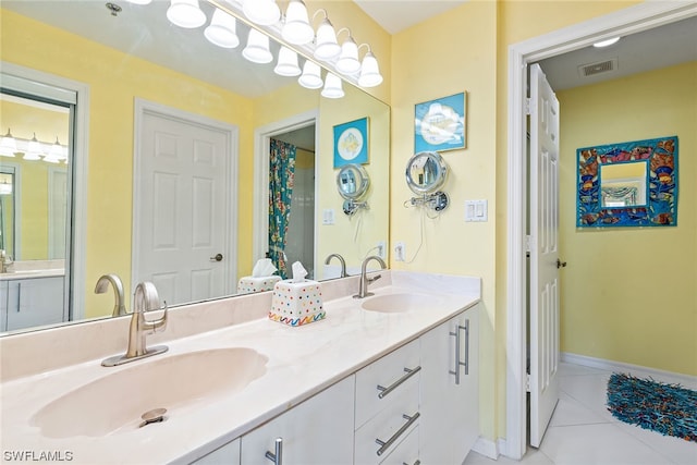 bathroom with tile patterned flooring and vanity