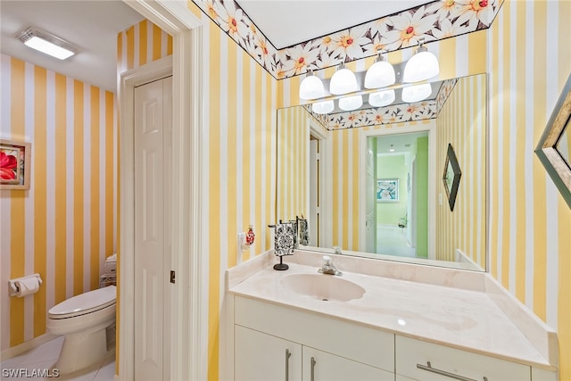 bathroom featuring tile patterned floors, vanity, and toilet