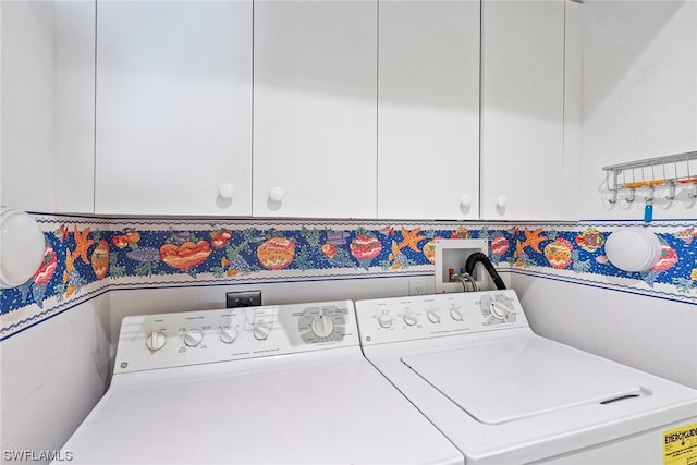 washroom featuring cabinets and separate washer and dryer