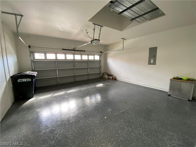 garage with a garage door opener and electric panel